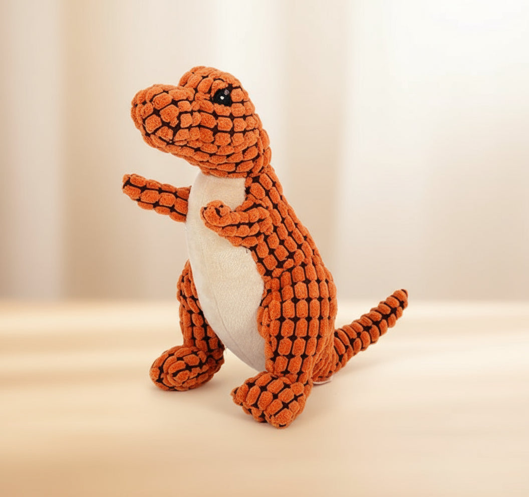 Plush dinosaur toy with orange body and beige belly on a white background