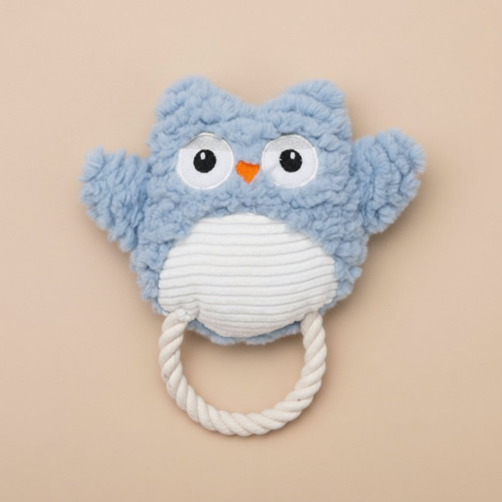 Blue owl-shaped toy with a white rope on a white background
