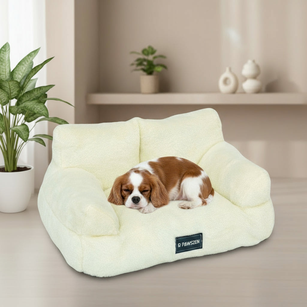 Cream-colored pet bed with a visible brand label on a white background